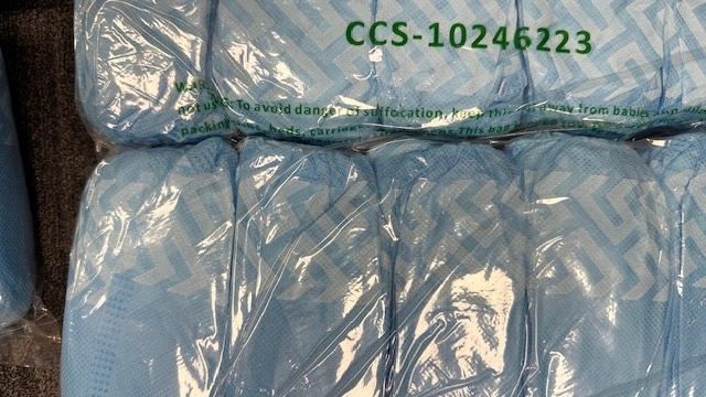 Disposable blue shoe and boot covers in bulk packaging